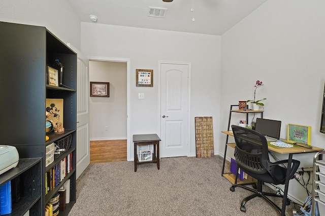 carpeted home office with ceiling fan, visible vents, and baseboards