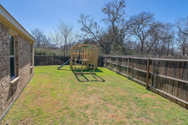 view of yard with a playground and a fenced backyard