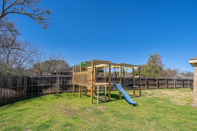 view of jungle gym with a fenced backyard and a lawn