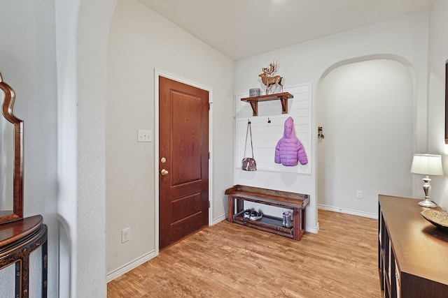 foyer entrance featuring light wood finished floors and baseboards