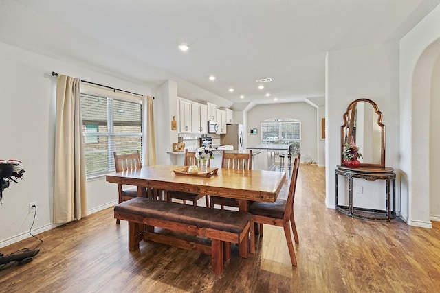 dining space with lofted ceiling, recessed lighting, visible vents, baseboards, and light wood finished floors