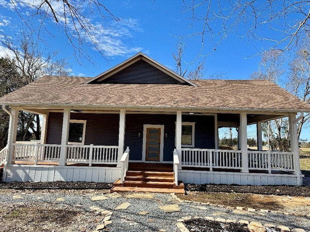 view of front of home with a porch and a shingled roof