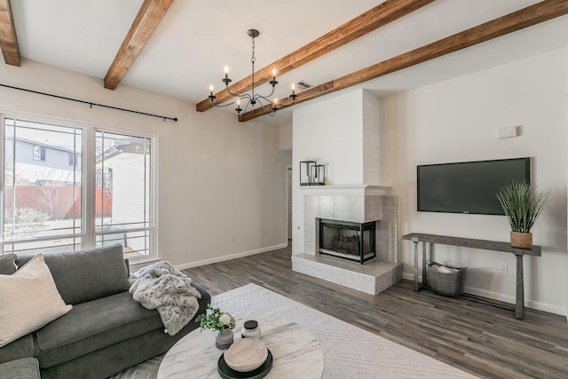 living area featuring a fireplace, wood finished floors, a chandelier, beamed ceiling, and baseboards