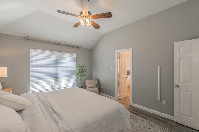 bedroom featuring lofted ceiling, ceiling fan, connected bathroom, wood finished floors, and baseboards