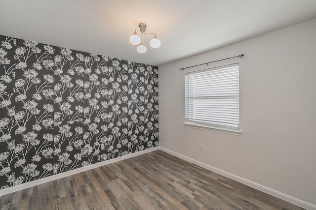 spare room with wood finished floors and baseboards