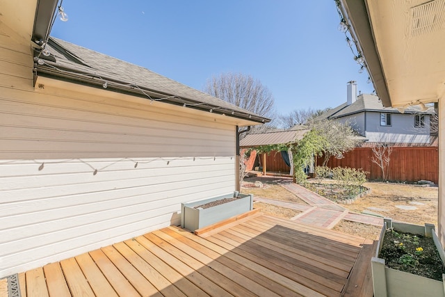 deck with a garden and fence