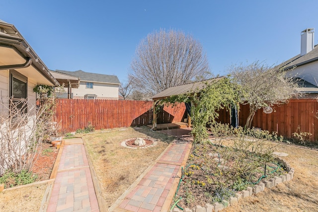 view of yard with a fenced backyard and a garden