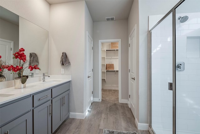 841 Holler Loop, Fort Worth, TX 76247 - bathroom with a shower stall, double vanity, wood finished floors, and a spacious closet