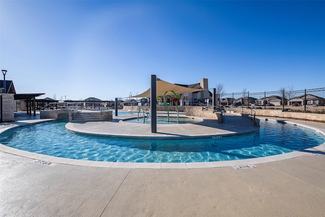 view of pool featuring playground community and fence