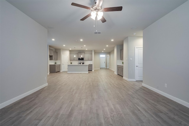 unfurnished living room featuring visible vents, baseboards, recessed lighting, light wood-style flooring, and a ceiling fan