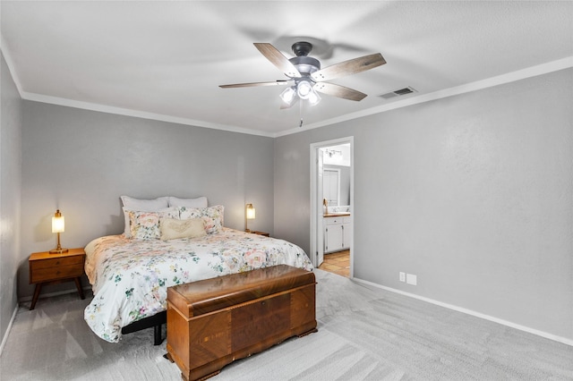 bedroom featuring baseboards, visible vents, ornamental molding, ensuite bathroom, and carpet