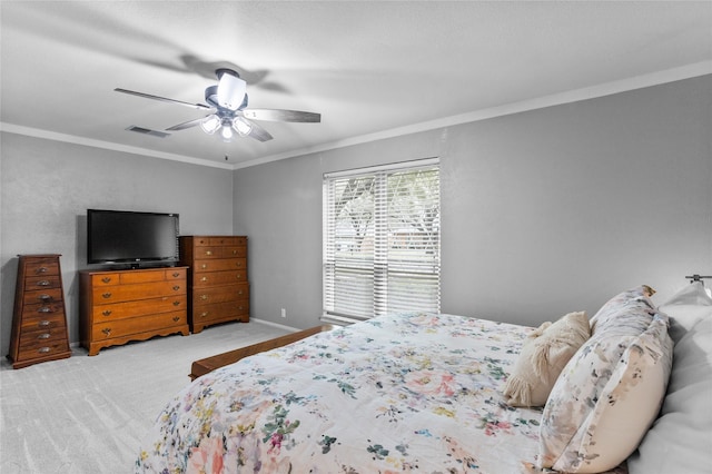 bedroom with visible vents, baseboards, a ceiling fan, ornamental molding, and carpet floors