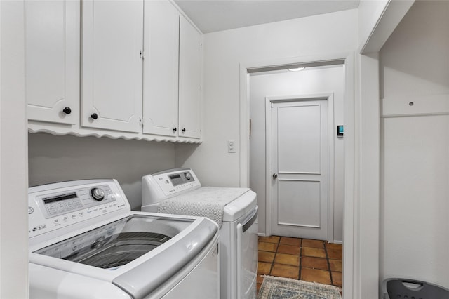 clothes washing area with cabinet space and washing machine and clothes dryer