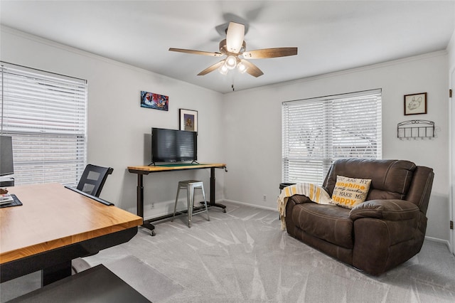 carpeted office featuring ornamental molding, ceiling fan, and baseboards