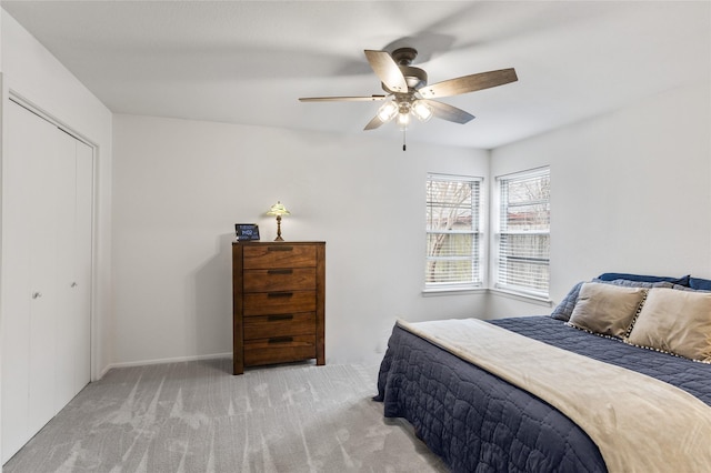 carpeted bedroom featuring a closet and ceiling fan