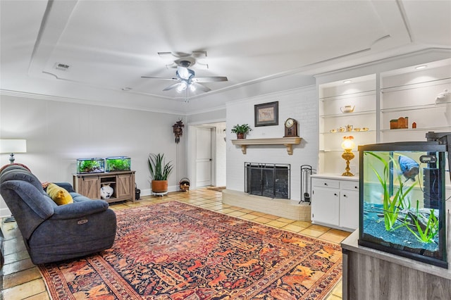 living area with light tile patterned floors, visible vents, a ceiling fan, crown molding, and a fireplace