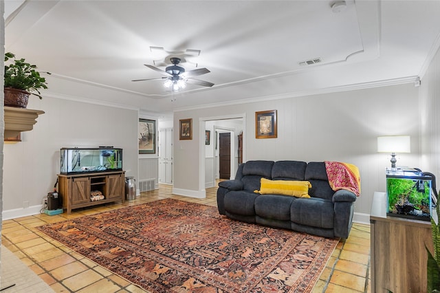 tiled living area featuring a ceiling fan, baseboards, visible vents, and crown molding