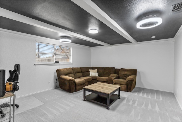 living area with a textured ceiling, carpet, visible vents, and baseboards