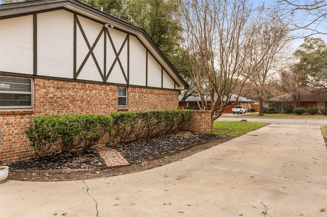 view of side of home with brick siding and stucco siding