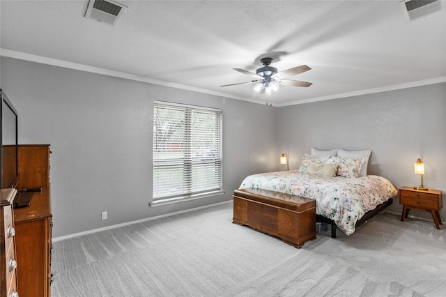 carpeted bedroom with ceiling fan, ornamental molding, visible vents, and baseboards