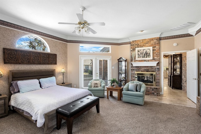 carpeted bedroom with multiple windows, visible vents, a fireplace, and crown molding