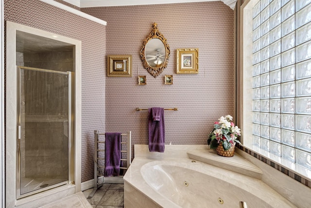 bathroom featuring baseboards, a tub with jets, a shower stall, and wallpapered walls