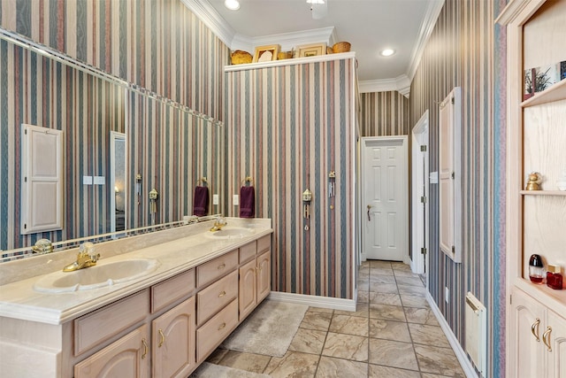 full bath featuring crown molding, baseboards, a sink, and wallpapered walls