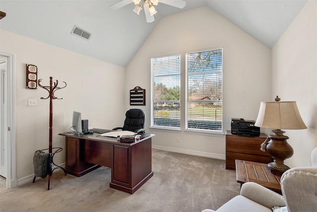 office featuring light carpet, visible vents, baseboards, vaulted ceiling, and a ceiling fan