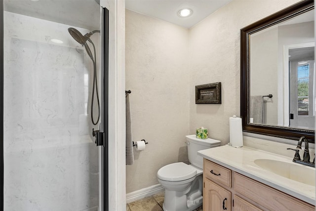 full bathroom featuring a stall shower, baseboards, a textured wall, toilet, and vanity