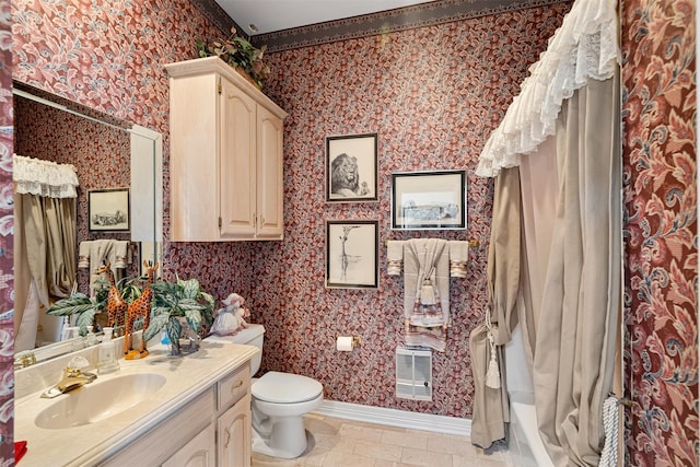 full bathroom with toilet, wallpapered walls, baseboards, and vanity