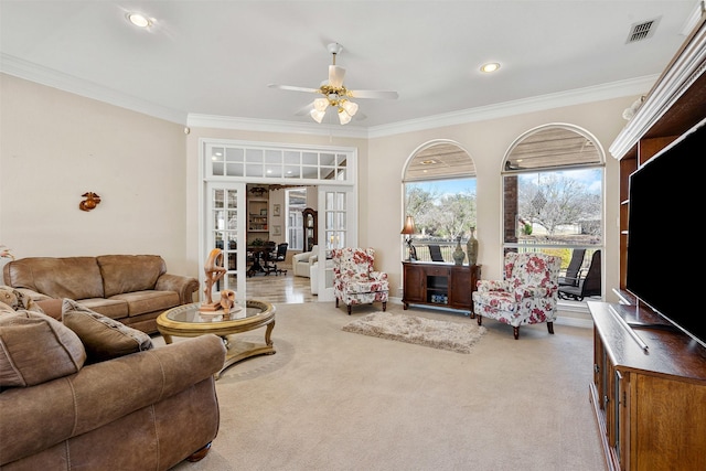 carpeted living area featuring visible vents, a ceiling fan, ornamental molding, french doors, and recessed lighting