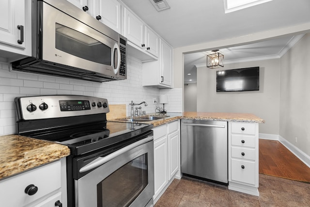 kitchen with stainless steel appliances, ornamental molding, visible vents, and white cabinetry