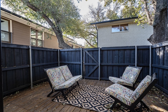 deck at twilight with fence and an outdoor living space