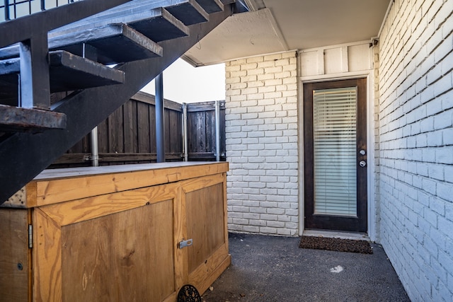 view of exterior entry with brick siding