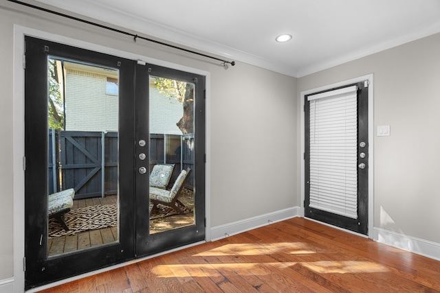 entryway featuring recessed lighting, baseboards, ornamental molding, french doors, and wood-type flooring