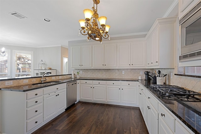 kitchen with a chandelier, a sink, visible vents, dishwasher, and stainless steel microwave