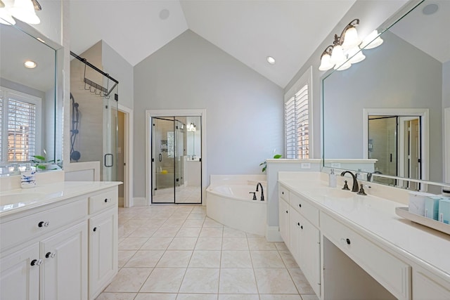 full bathroom with a garden tub, two vanities, a sink, a shower stall, and tile patterned floors