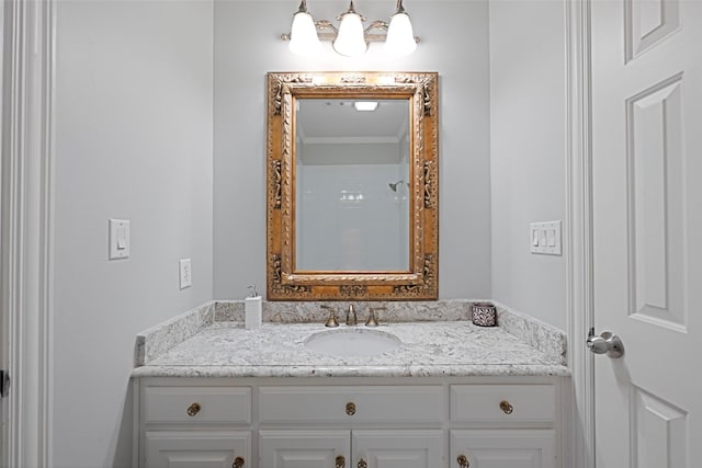 bathroom with ornamental molding and vanity