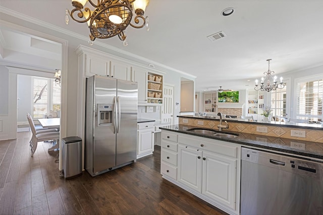 kitchen with stainless steel appliances, a sink, visible vents, open shelves, and an inviting chandelier