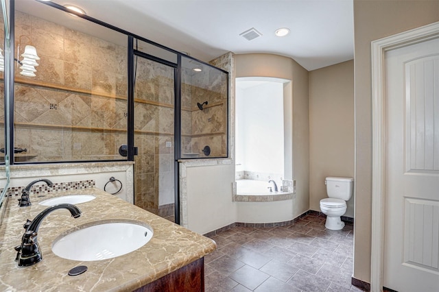 full bathroom featuring a garden tub, a shower stall, visible vents, and a sink