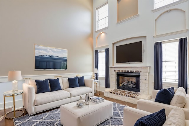 14124 Rodeo Daze Dr, Fort Worth, TX 76052 - living area with a wainscoted wall, a high ceiling, and a fireplace with raised hearth