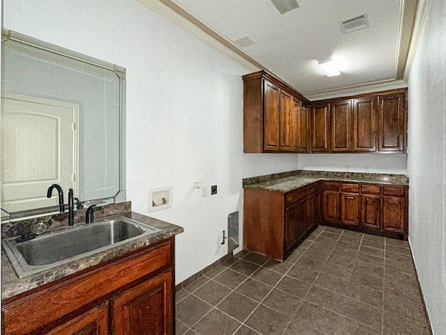 clothes washing area with washer hookup, a sink, visible vents, cabinet space, and crown molding