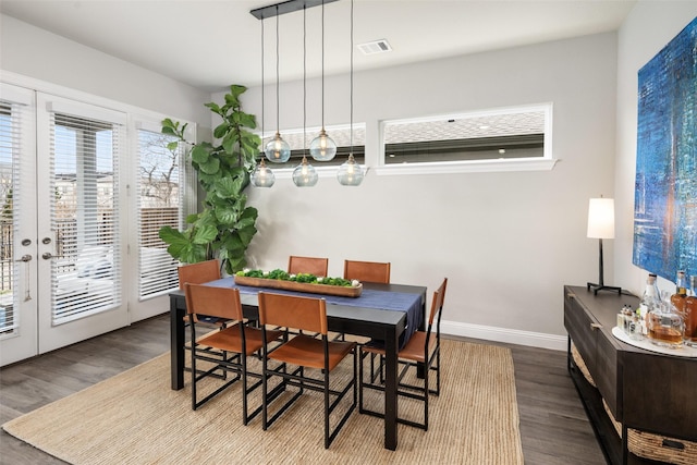 dining area with baseboards, visible vents, wood finished floors, and french doors