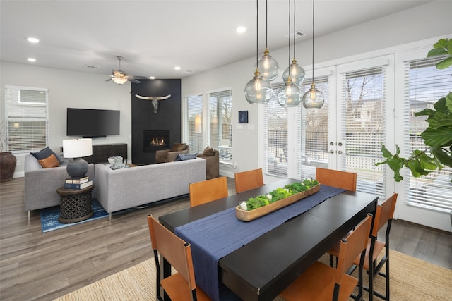 dining area featuring a fireplace, recessed lighting, visible vents, light wood-style flooring, and ceiling fan