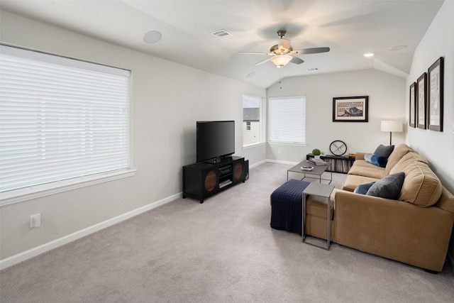 living area with vaulted ceiling, baseboards, visible vents, and light colored carpet