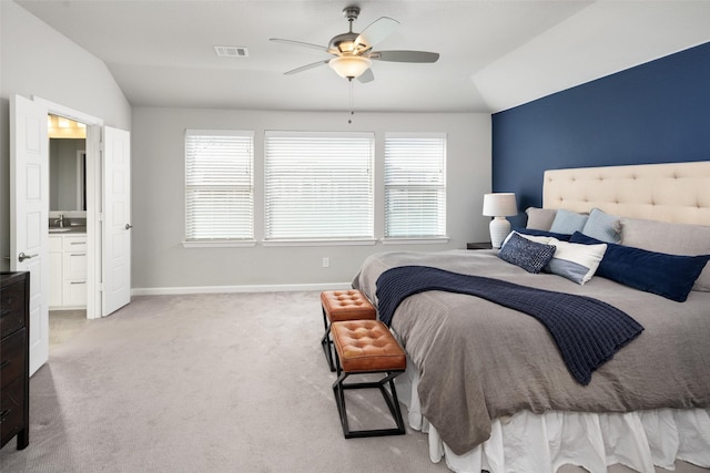 bedroom featuring lofted ceiling, a sink, carpet flooring, visible vents, and baseboards