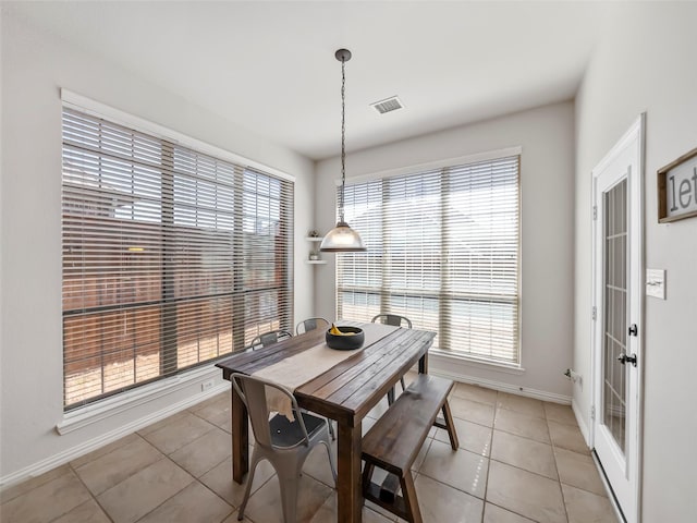 dining area with visible vents, baseboards, and light tile patterned floors