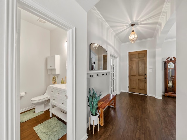 entryway featuring baseboards, crown molding, visible vents, and dark wood-style flooring