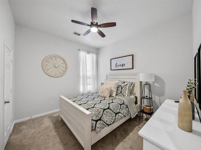 bedroom featuring baseboards, carpet floors, visible vents, and a ceiling fan