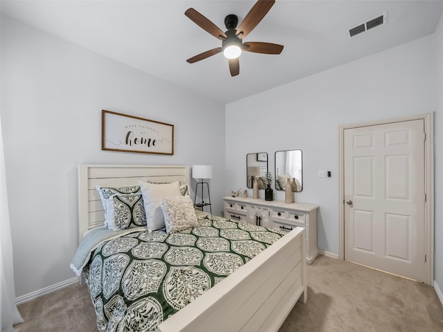 bedroom featuring light carpet, baseboards, and visible vents